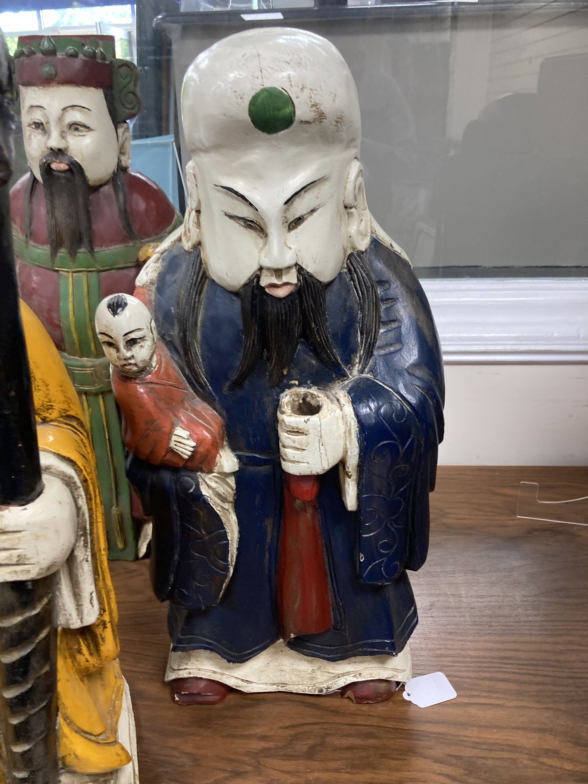 A trio of polychrome painted carved Chinese hardwood figures, tallest 67cm